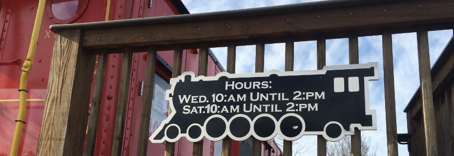 Museum Hours on display on the Caboose Deck