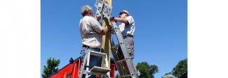 Chapter members install a cross-buck at the Museum complex